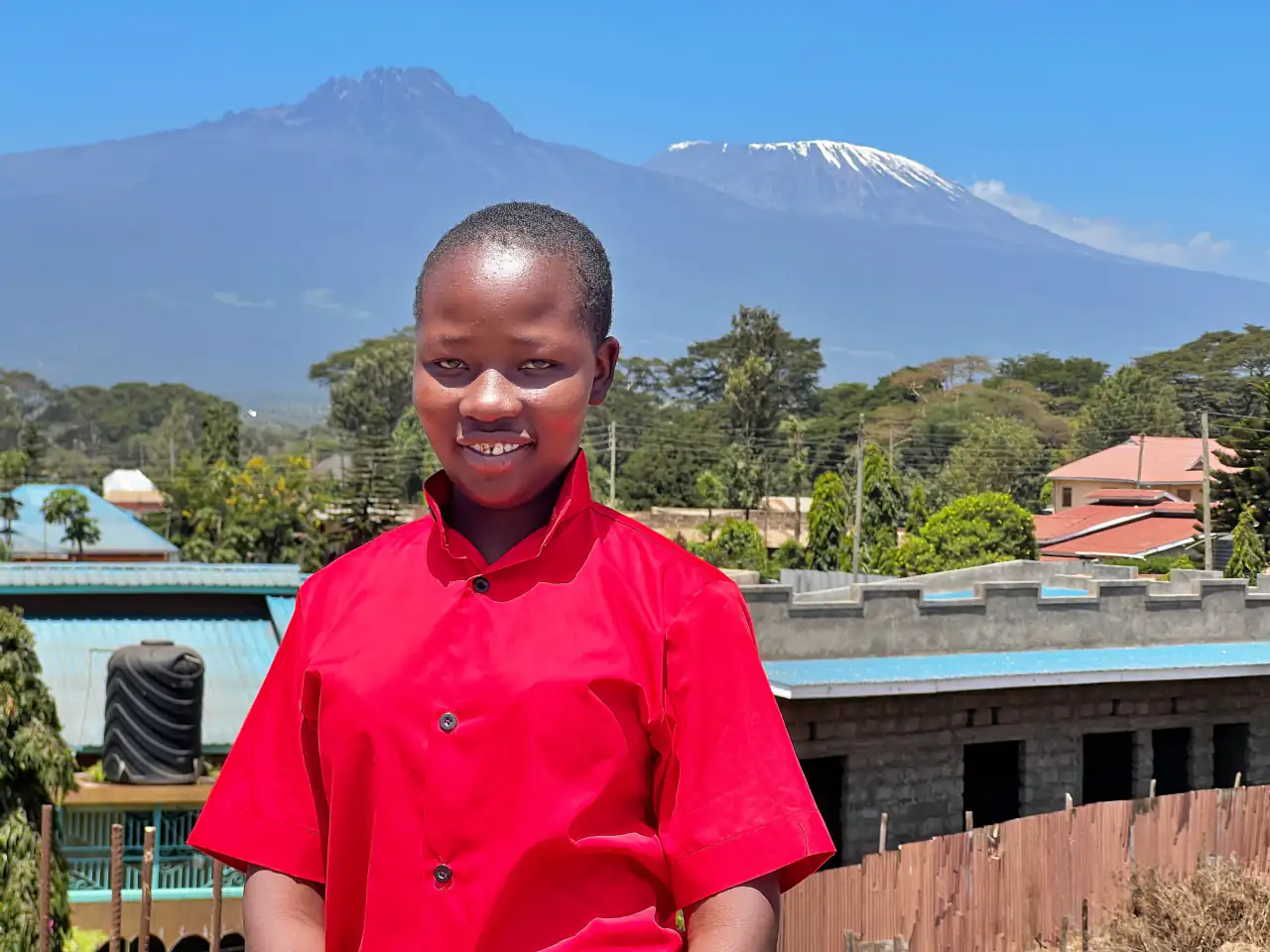 An ADEA student in front of Mount Kilimanjaro, Rombo, Kenya